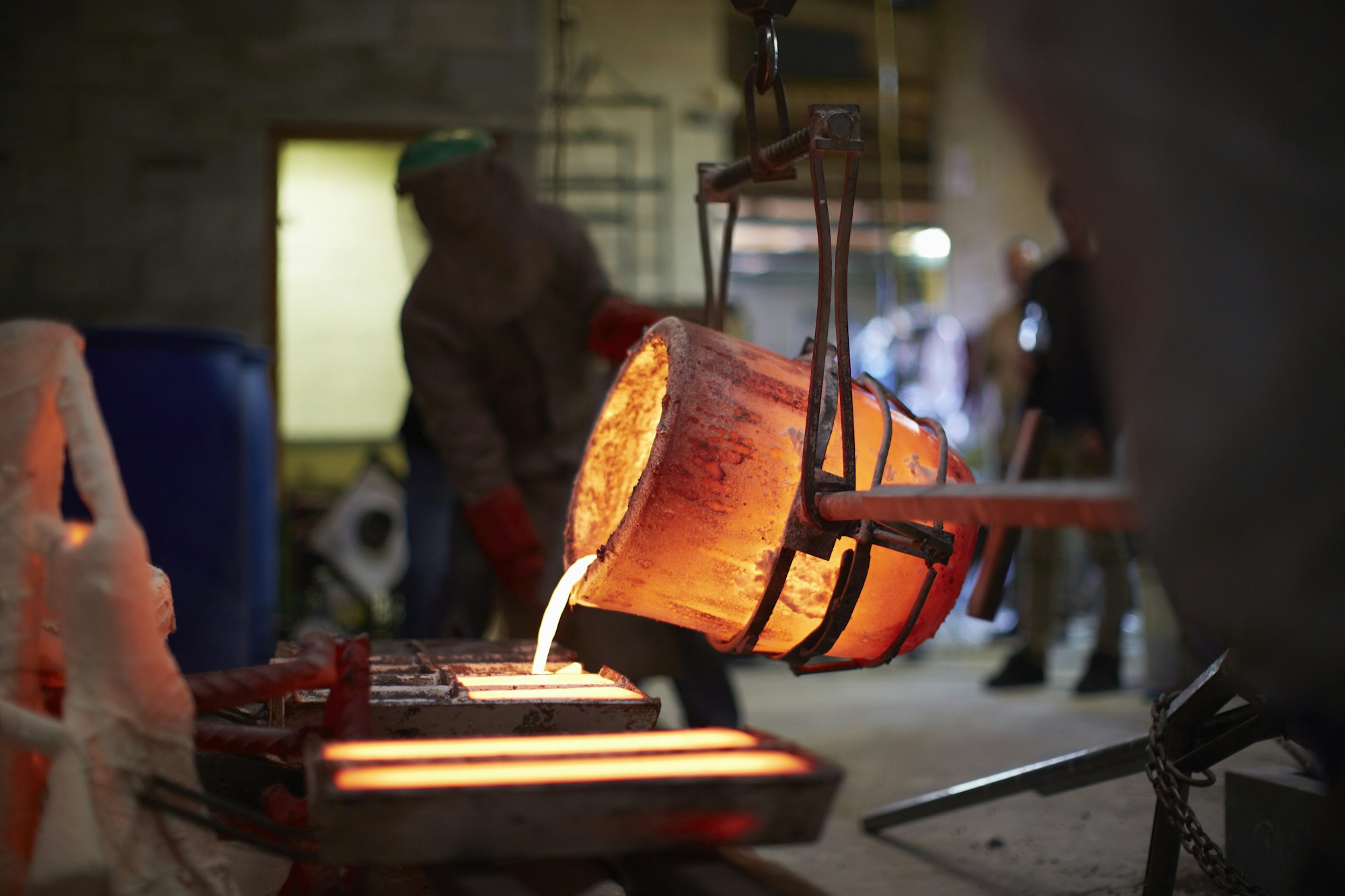 South Africa, Cape Town, Molten bronze being poured into shells for casting